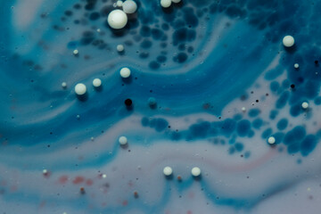 Painted Galaxy Art Created in Oil and Milk. Galaxies evolve in this artistic science experiment. Alien landscape. Purple, red and blue abstract formations take shape in an alternate universe.