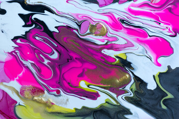 Pink, black and white mixed inks spilled on white background. Golden glitter texture.