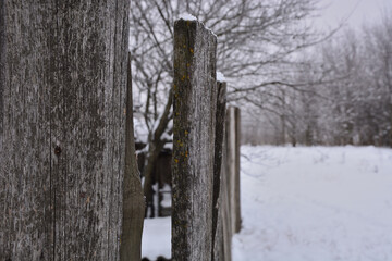 Old village fence . The photo was taken in winter .