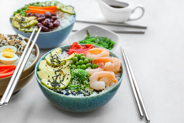 Different poke bowls on light background