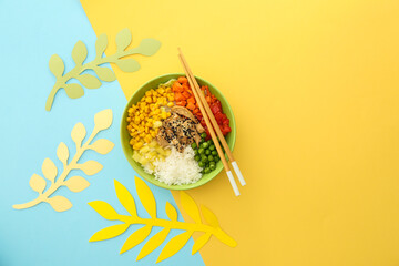 Bowl with tasty rice, chicken and vegetables on color background