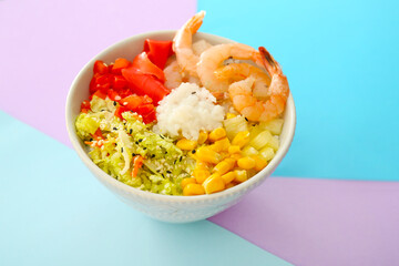 Bowl with tasty rice, shrimps and vegetables on color background