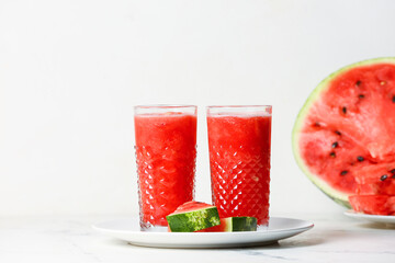Glasses with fresh watermelon juice on white background