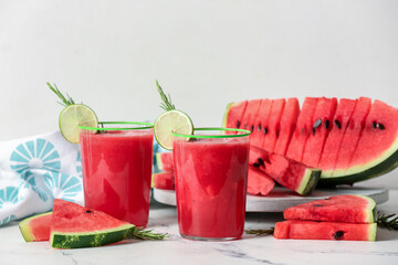 Glasses with fresh watermelon juice on light background