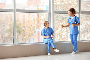 Female doctors drinking coffee in clinic