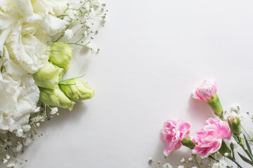Flower frame, eustoma of a white and delicate color on a light background.