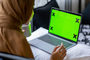 Islamic woman use laptop with greenscreen.