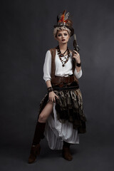 Beautiful girl in steampunk style costume with hat and handgun