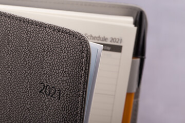 2021 schedule book and pen on gray background.