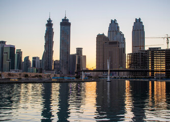 Fototapeta na wymiar Dubai, UAE - 01.08.2021 View of the Dubai city skyline at Dubai Water Canal. Business Bay district. Outdoors
