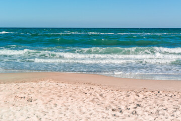 Fototapeta na wymiar Landscape of sandy coast and sea with waves