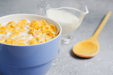 Corn flakes in milk. Blue Cup. Healthy and nutritious Breakfast. Copy space