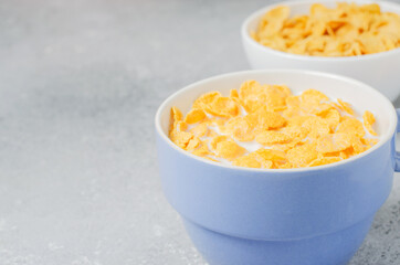 Corn flakes in milk. Blue Cup. Healthy and nutritious Breakfast. Copy space