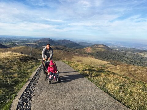 Man Pushing Baby Carriage On Road