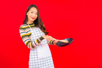 Portrait beautiful young asian woman with pan ready to cook