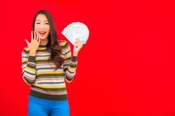 Portrait beautiful young asian woman with cash money and mobile phone