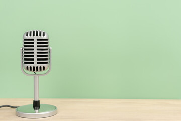 Microphone retro with copy space on table and greed background