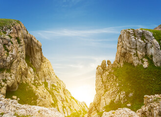 view to a sunset from a crack in the mountain