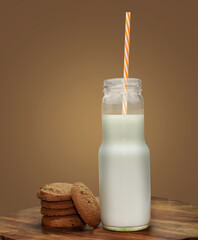Chocolate Cookies with milk bottle on dark background