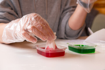 Chemistry education and training concept. Close-up of a woman dipping a cone into a solution in a...