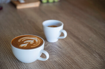 Cup of coffee on table in coffee shop cafe.