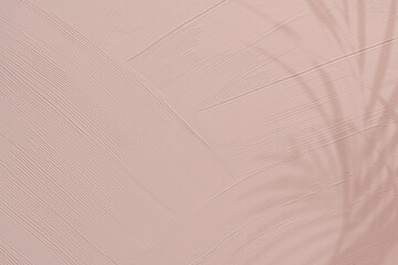 Dull pink paint texture background with leaf shadow