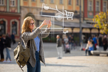 Augmented reality in marketing. Woman traveler with phone. Navigation on the projection of the...