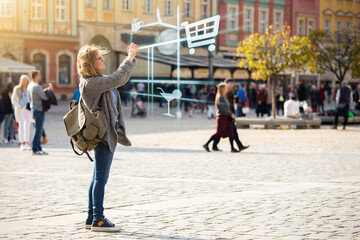 Augmented reality in marketing. Woman traveler with phone. Navigation on the projection of the display	
