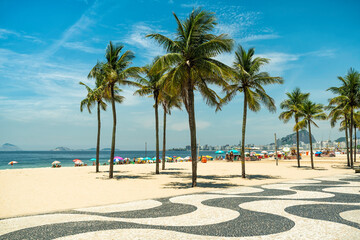 Sunny day on Copacabana Beach with palm trees in Rio de Janeiro, Brazil - obrazy, fototapety, plakaty