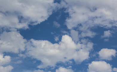 White scattered clouds against a blue sky.