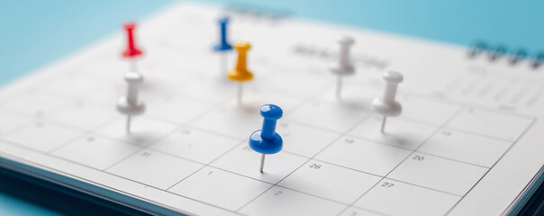 Calendar on solid ิblue background with copy space, pinned in a calender on datebusiness meeting...