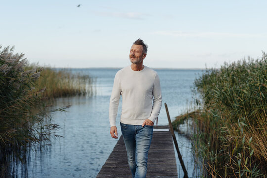 Attractive middle-aged man posing on a jetty