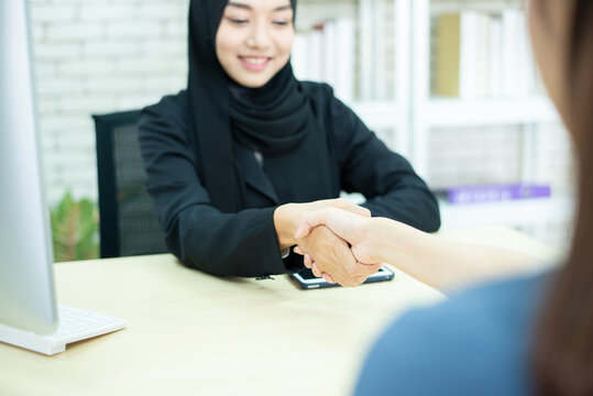 closed up hand cheacking of two woman one in muslim hijap hand hold tablet one dress in modern siut hand hold smart phone,success business concept.