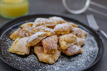 Austrian cuisine. Torn pancake (or omelet) kaiserschmarrn with honey, powdered sugar