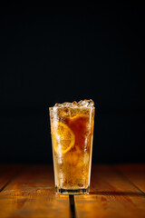 Fresh fizz long island ice tea cocktail in a glass on the wooden table