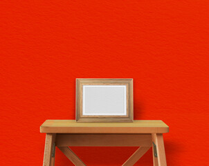 Wooden table on yellow wall with photoframe