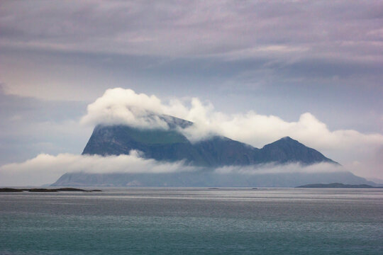 The famous Haja island off the coast of northern Norway, surrounded by clouds