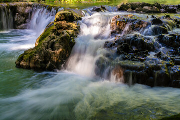 Fototapeta na wymiar Beautiful waterfall in tropical rainforest green tree background