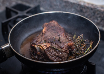 An image of a steak pan seared in butter and rosemary