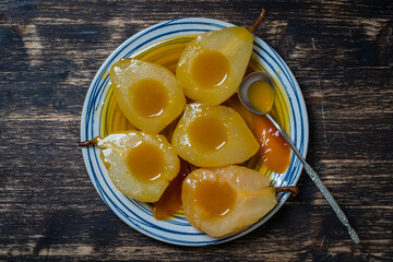 Baked pears in orange juice, close up. Delicious dessert.