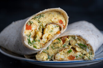 Burrito wraps with egg omelet and vegetables in pita bread