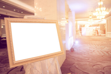 Blank Golden vintage photo frame at entrance wedding hall..Blank photo frame with copy space at hotel.Blank advertising billboard..Poster media template Ads display with copy space,