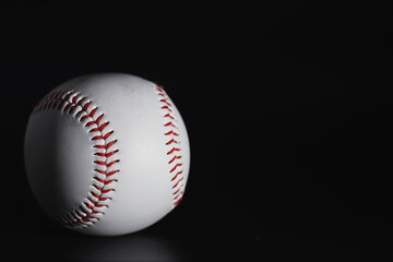 American traditional sports game. Baseball. Concept. Baseball ball and bats on a black table.
