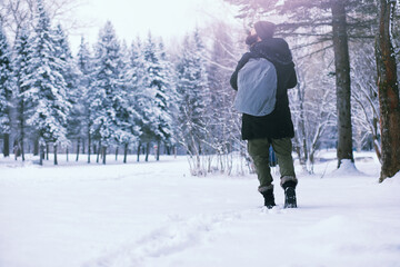 Bearded man in the winter woods. Attractive happy young man with beard walk in the park.