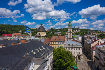 Naklejka na ściany i meble Aerial view on Market square, Dormition, Dominican and Carmelite Church in Lviv, Ukraine from drone