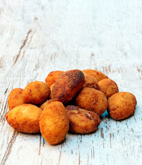 Croquettes surrounded by rustic background