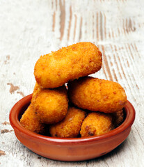 Croquettes surrounded by rustic background