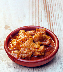 Spanish callos surrounded by rustic background