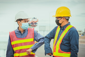 Two worker shake hand elbow prevention covid19 coronavirus, Man wear face mask
