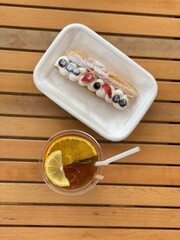 Cute decorated Dessert and beverage on white wood table in cafe
